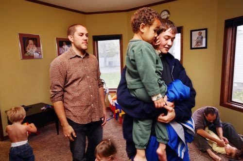 Ashley Tremont and her son Zyan, 3, prepare to leave the communal home after staying the night on an invitation from Jeromy Emerling, who met them at a homeless shelter. Helping others is a part of the community service that Jeromy hopes the group can do more of.