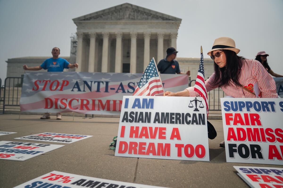 People setting up signs and banners outside the U.S. Supreme Court