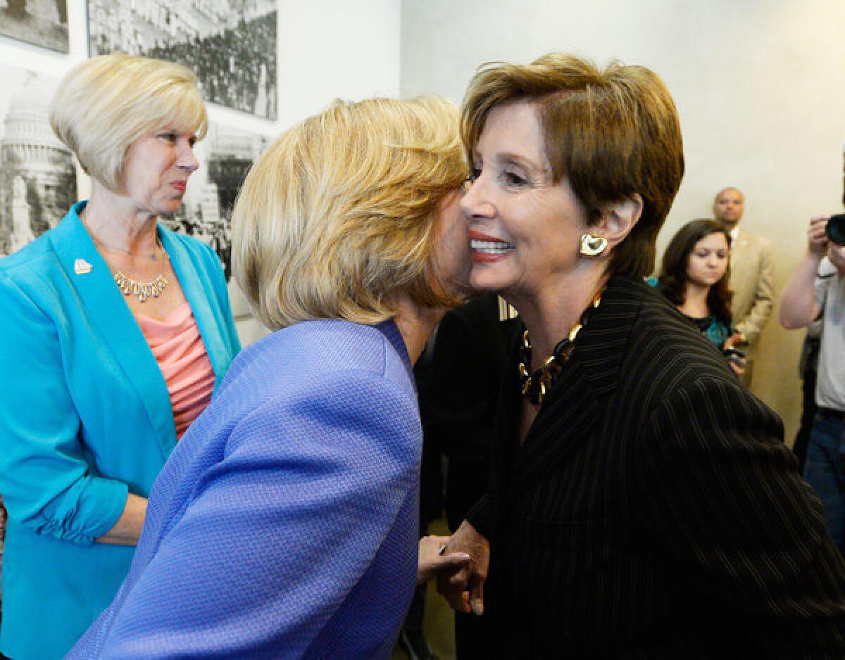 Los Angeles mayoral candidate Wendy Greuel, left, and U.S. House Democratic leader Nancy Pelosi hug at a meeting of the Feminist Majority Foundation on April 4, 2013, in Beverly Hills.