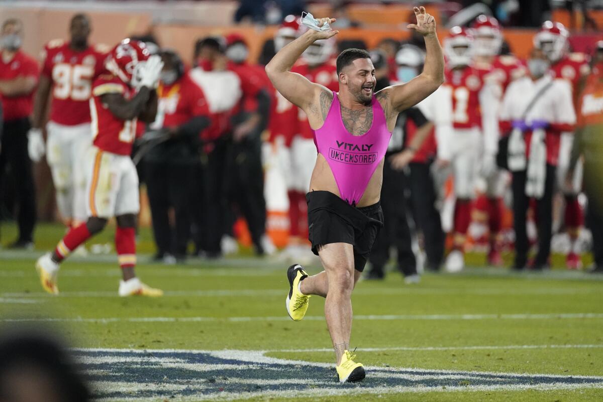 A prankster runs on the field in a pink women's swimsuit during the 2021 Super Bowl