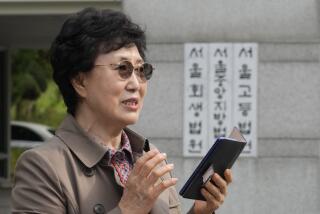 Han Tae-soon speaks during a press conference in front of the Seoul Central District Court in Seoul, South Korea Monday, Oct. 7, 2024 before she sues her government, an adoption agency and an orphanage over the adoption of her daughter. (AP Photo/Ahn Young-joon)