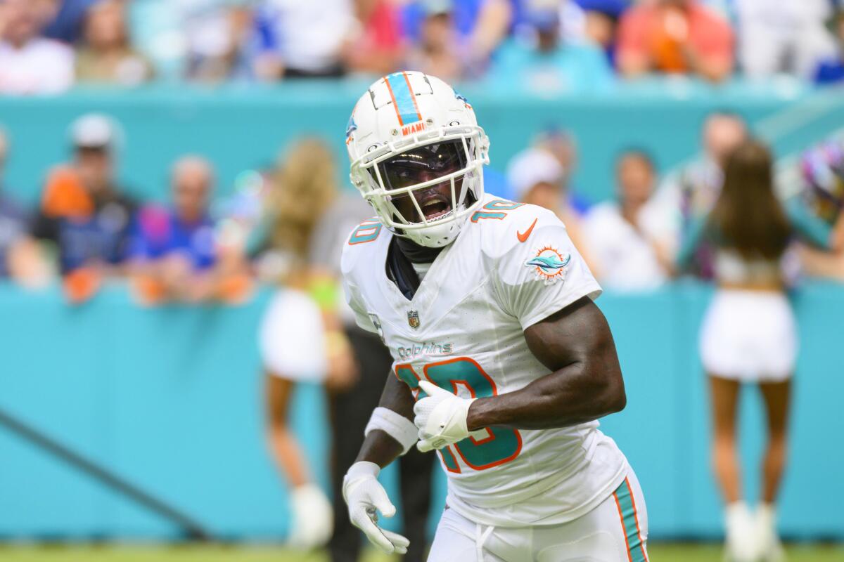 Miami Dolphins wide receiver Tyreek Hill runs off of the field.