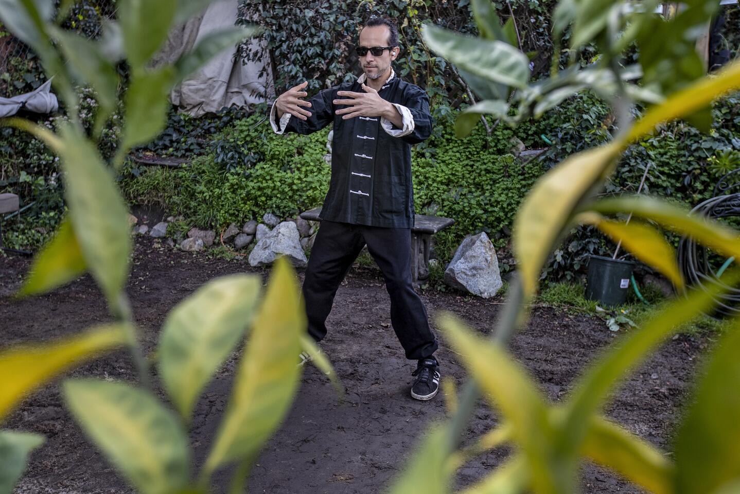 Paul Terry practices tai chi in his Inglewood garden.