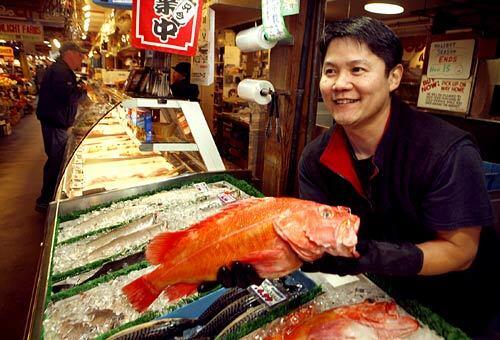 Ray Ogura shows off a red snapper at the Seafood City fish market in the public market on Granville Island, a must-see shopping district in downtown Vancouver, Canada.