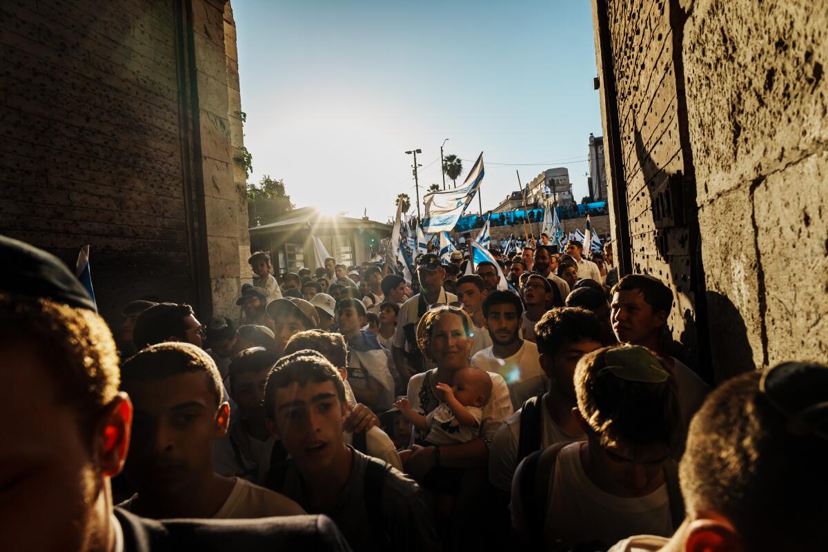 Protesters march through a narrow passageway 