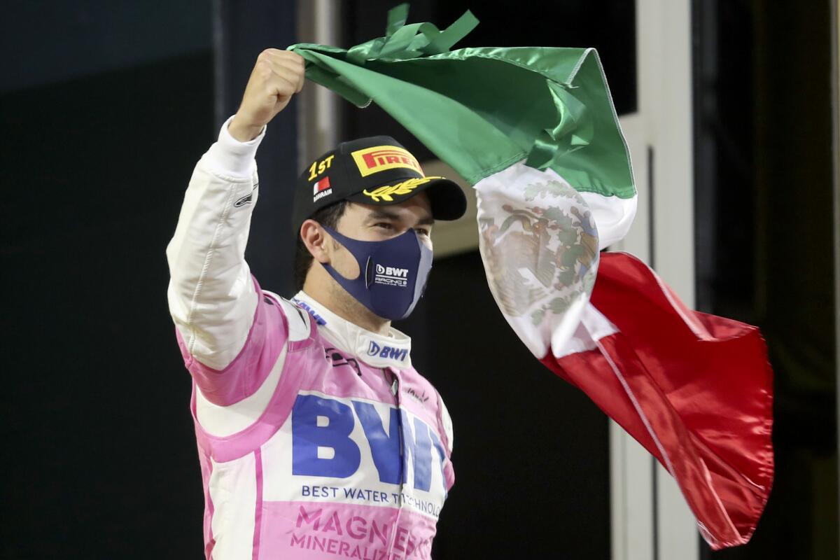 Sergio Perez waves a flag to celebrate his victory