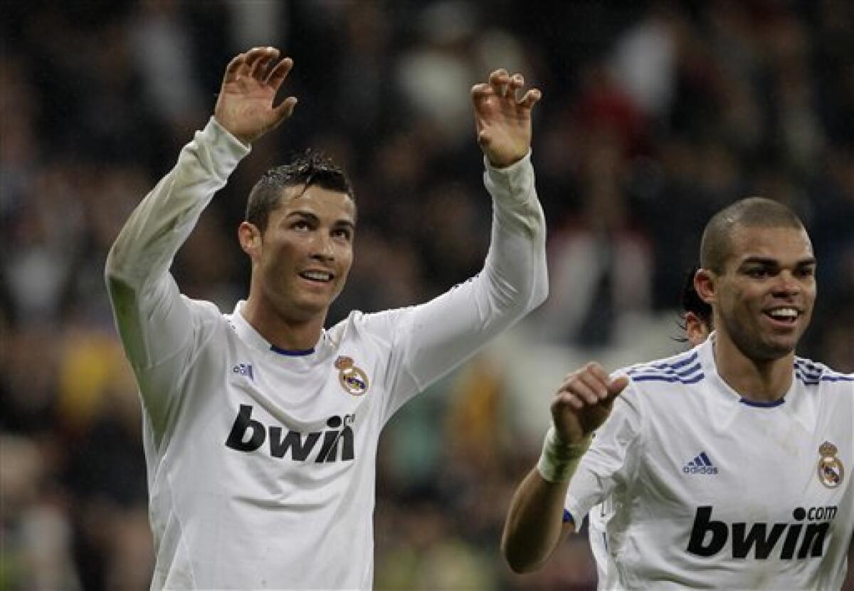 Real Madrid's Cristiano Ronaldo from Portugal, left celebrates with Pepe from Portugal after scoring against Levante during a Spanish Copa del Rey soccer match at the Bernabeu stadium in Madrid, Wednesday Dec. 22, 2010.(AP Photo/Paul White)