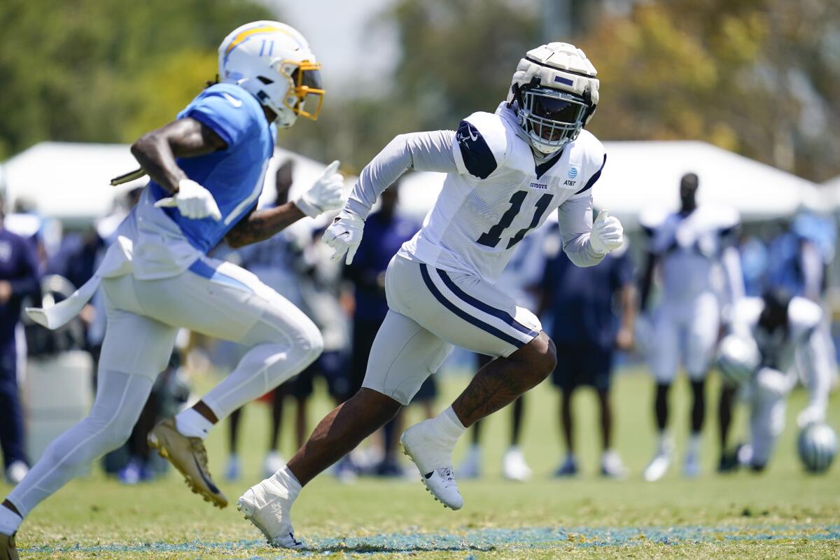 Chargers wide receiver Jason Moore Jr. and Dallas Cowboys outside linebacker Micah Parsons participate in drills.