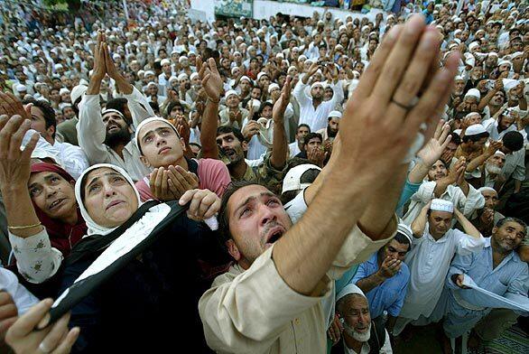 Kashmiri Muslims pray while facing the head priest who is displaying the holy relic believed to be hair from the beard of the Prophet Mohammed on the occasion of the Islamic festival of Shab-e-Meraj at Hazratbal Shrine in Srinagar, the summer capital of Indian Kashmir, on Thursday. Shab-e-Meraj is celebrated as the anniversary of the Prophet Mohammed's ascent to heaven.