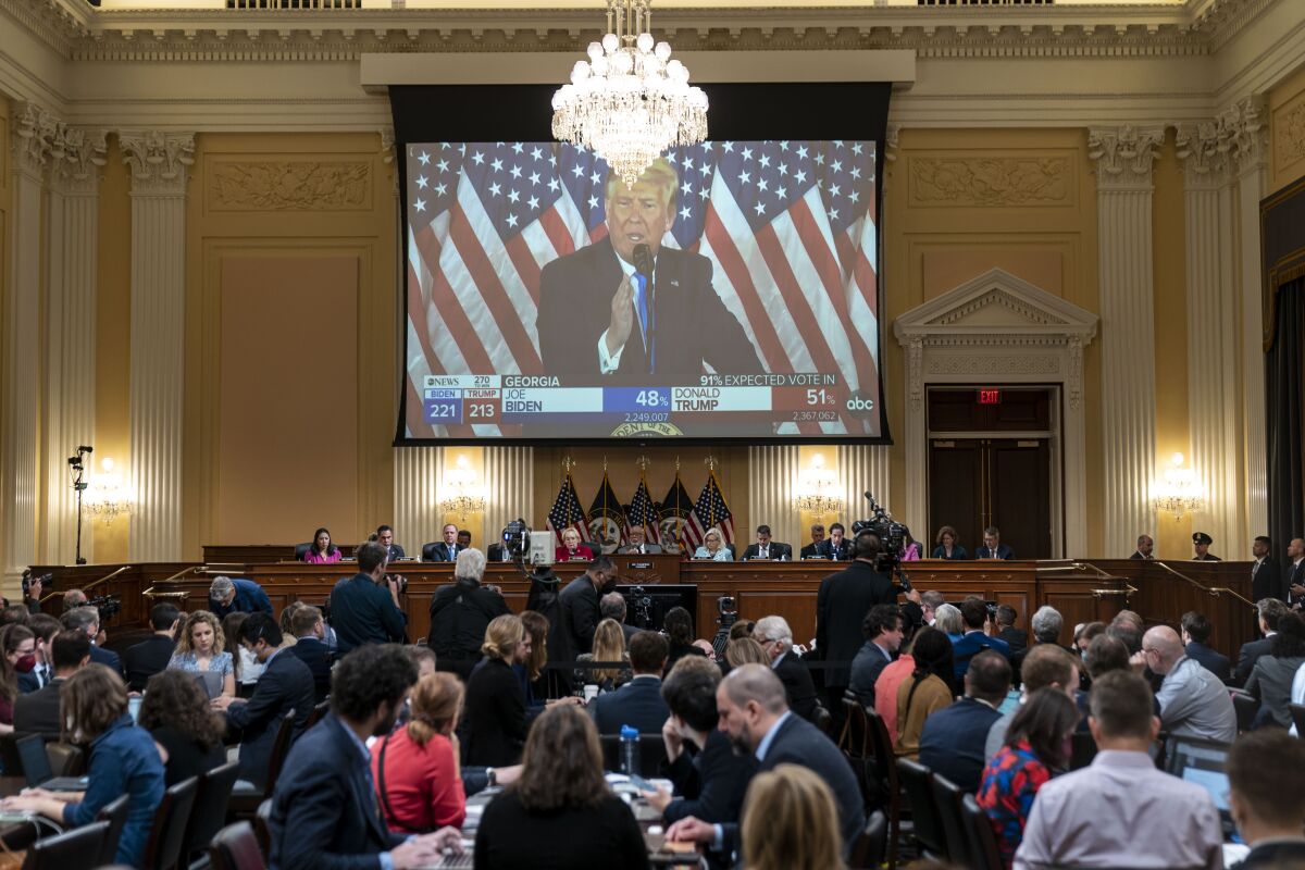  A video of former President Donald Trump is displayed on a screen.