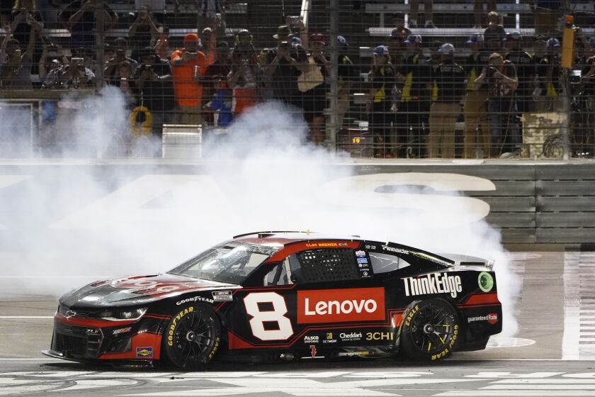 Tyler Reddick burns his tires after winning the the NASCAR Cup Series auto race at Texas Motor Speedway in Fort Worth, Texas, Sunday, Sept. 25, 2022. (AP Photo/Larry Papke)