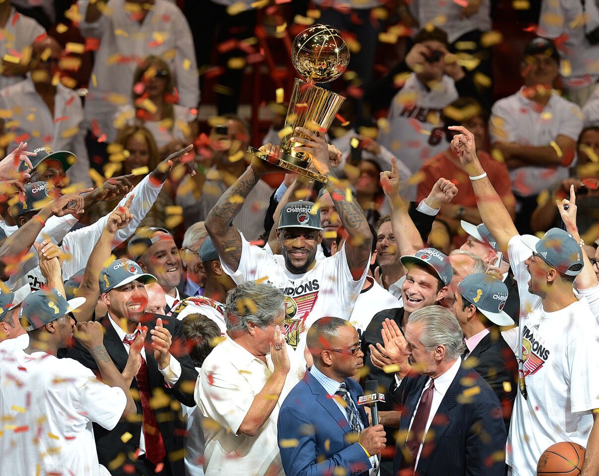 First championship: NBA Finals MVP LeBron James of the Miami Heat holds the championship trophy after defeating the Oklahoma City Thunder in Game 5 of the NBA Finals on June 21, 2012, at the American Airlines Arena in Miami.