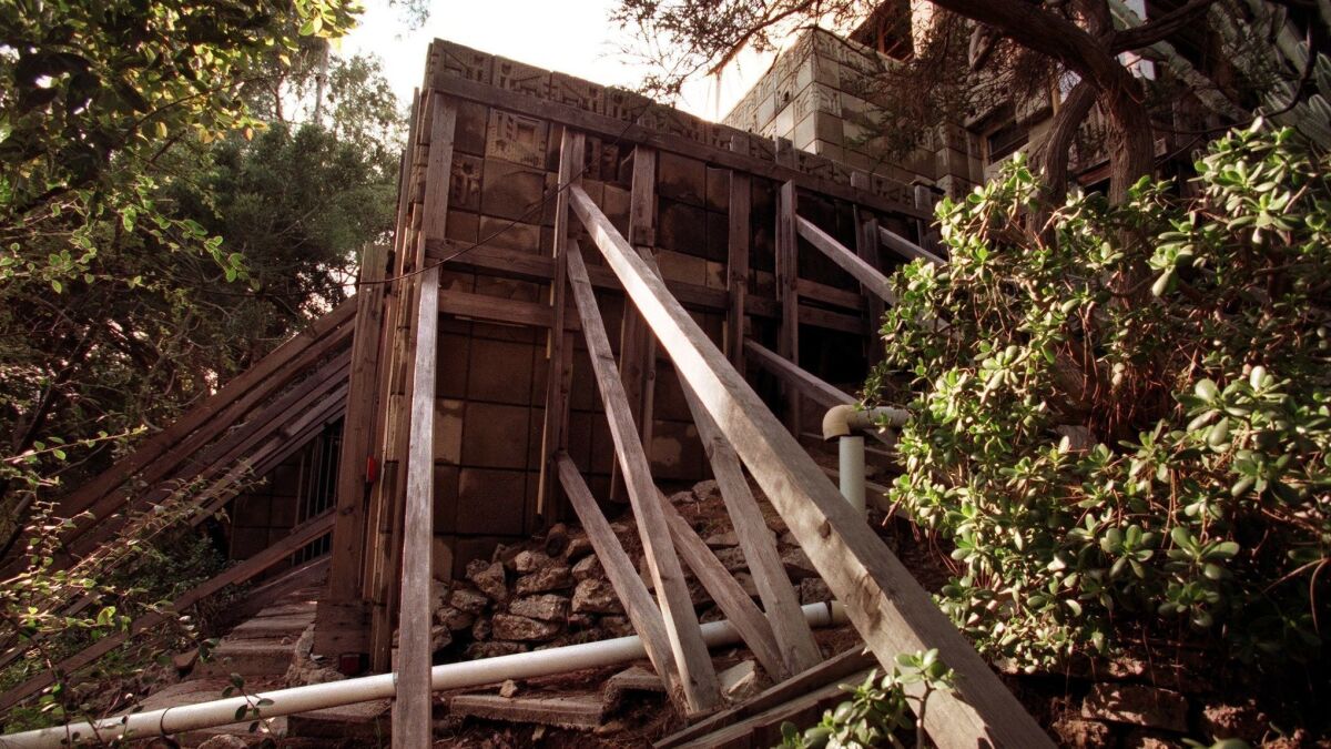 The Freeman House in 1998 was supported by braces and had a tent over its roof after the Northridge earthquake.