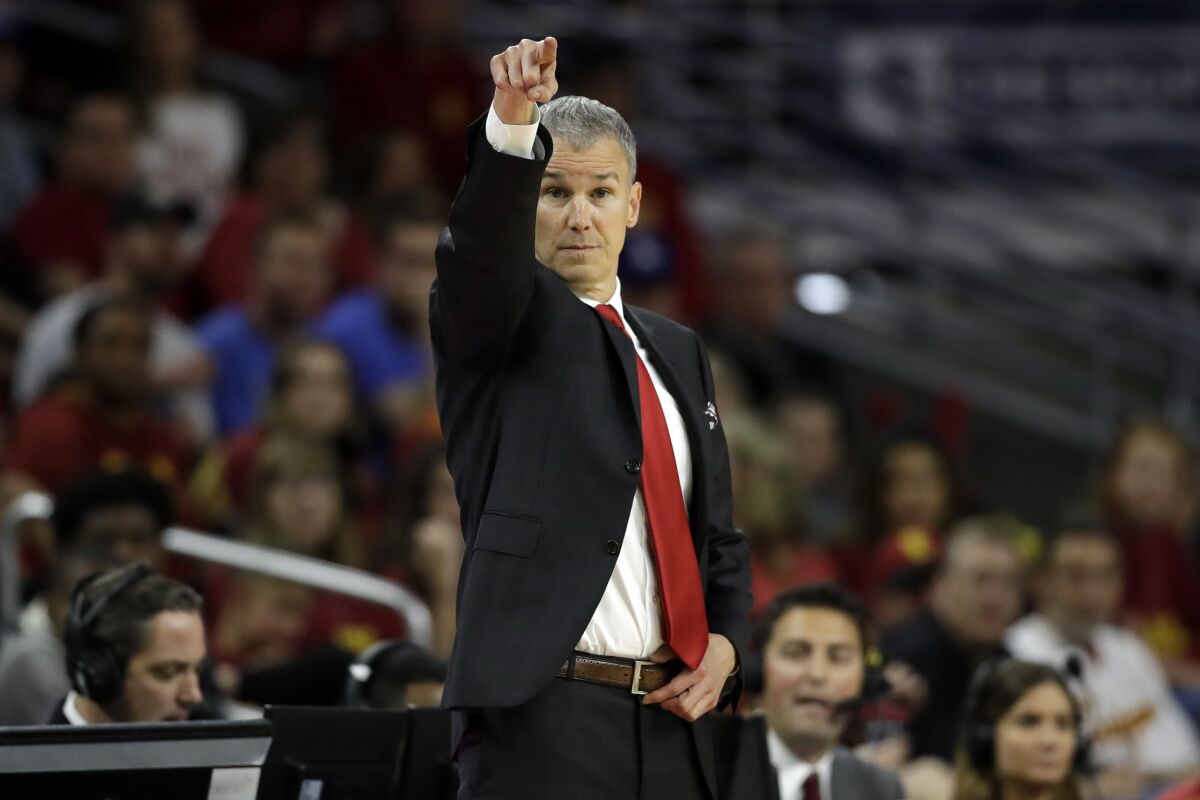 USC coach Andy Enfield signals during a game against UCLA