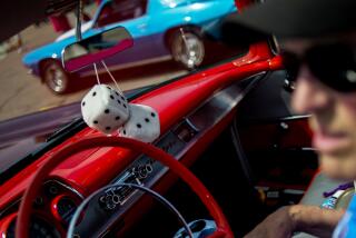 FILE - Fuzzy dice sit behind the rear-view mirror of a 1957 Chevrolet Bel Air, Aug. 4, 2014, in Flint Township, Mich. Starting Monday, Jan. 1, 2024, police there no longer will be allowed to pull over motorists solely because they have something hanging from the rearview mirror on their windshield. That means air fresheners, parking placards and, yes, even those dice are fair game to hang according to a revised Illinois windshield rule. (Jake May/The Flint Journal via AP)/The Flint Journal via AP)