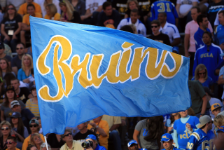 BOULDER, CO - SEPTEMBER 29: The Bruins flag flies as the UCLA Bruins score a touchdown against Colorado.