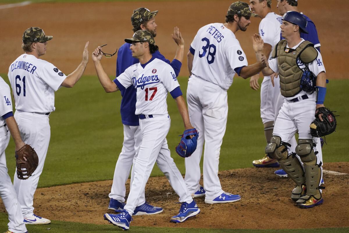 Dodgers players celebrate their 7-0 win over the Miami Marlins at Dodger Stadium on Saturday.