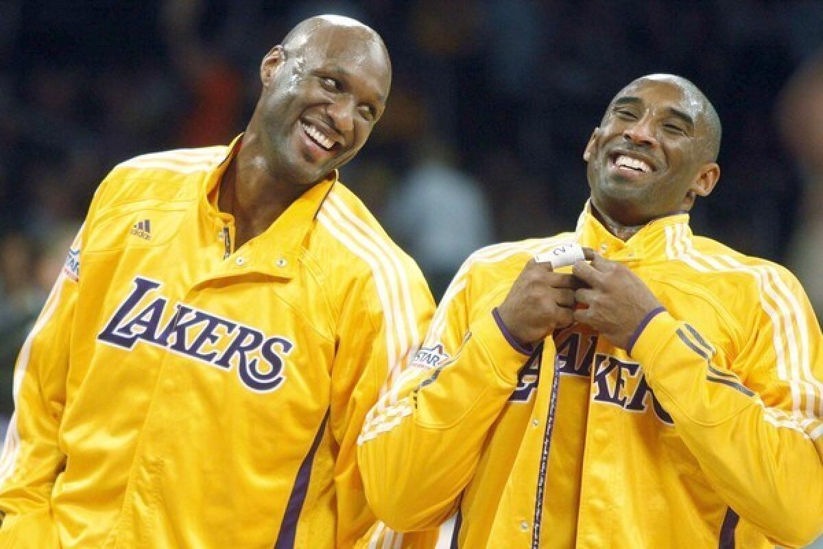 Kobe Bryant, right, shares a laugh with then-Lakers teammate Lamar Odom before a game in 2010.