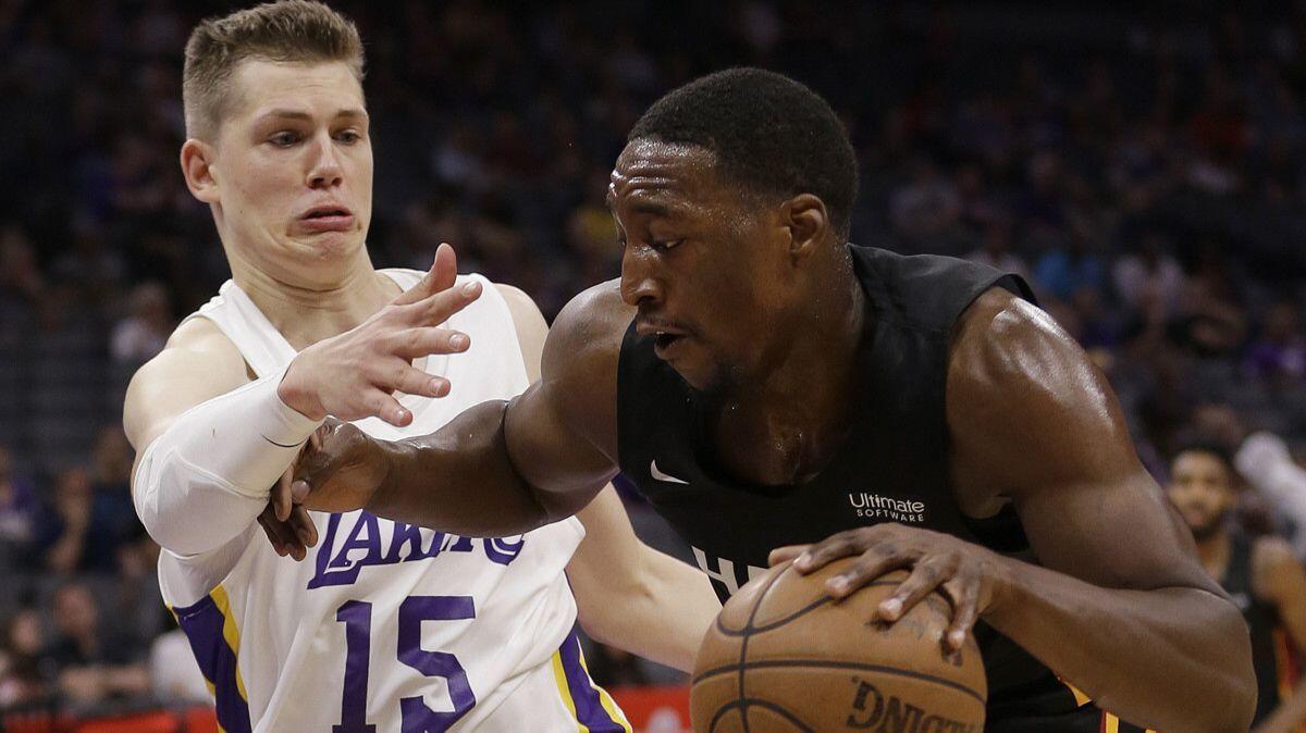 Lakers center Moritz Wagner, left, tries to stop Miami Heat center Bam Adebayo during the first half of a California Classic game on Tuesday in Sacramento.