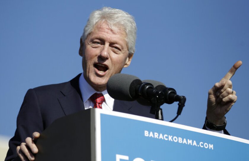 Former President Bill Clinton gestures while speaking at a campaign rally for President Obama at the University of Central Florida in Orlando, Fla.
