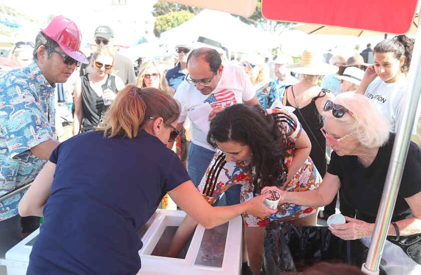 Alexis Braun, a senior recreation supervisor, hands out Jeni's ice cream cups.