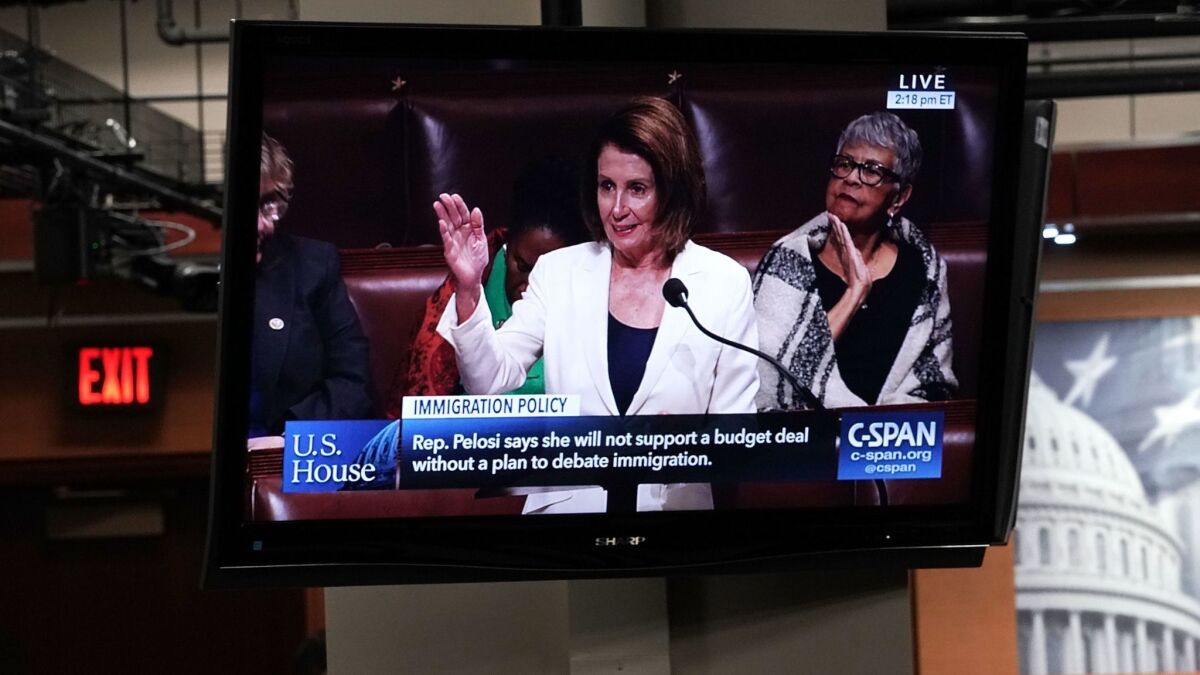 A TV shows Minority Leader Nancy Pelosi giving a lengthy immigration speech on the House floor on Wednesday.