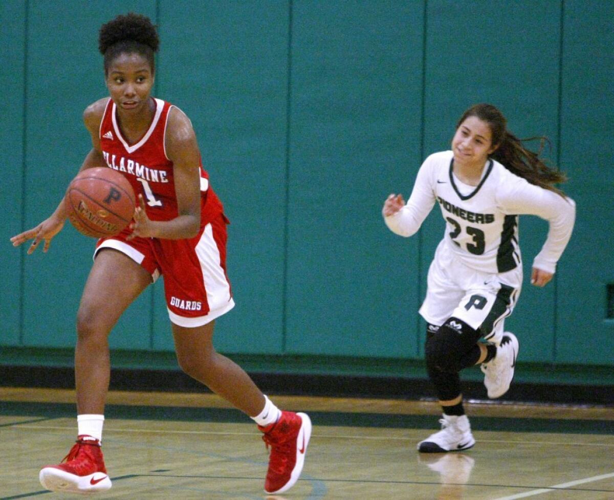 Bell-Jeff High girls' basketball player Claire Borot, left, moves the ball up court versus Providence High at the Providence Pioneer Showcase in Burbank on Saturday.