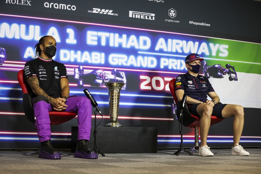 Mercedes driver Lewis Hamilton of Britain, let, and Red Bull driver Max Verstappen of the Netherlands speak during a press conference ahead of the Formula One Abu Dhabi Grand Prix in Abu Dhabi, United Arab Emirates, Thursday, Dec. 9, 2021. (Antonin Vincent, Pool via AP)