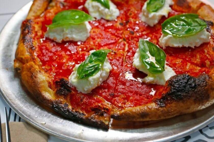 LOS ANGELES, CA. - JUNE 23, 2015: "LA woman": local burrata, tomato, basil, olive oil, sea salt pizza for Jonathan Gold food review of Jon & Vinny's in Los Angeles on June 23, 2015. (Anne Cusack/Los Angeles Times)