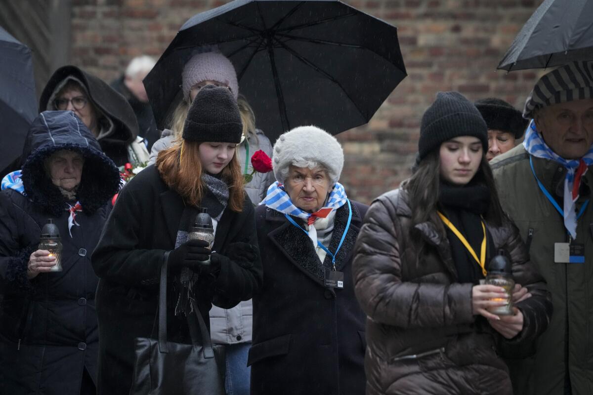 People stand at the Auschwitz Nazi death camp.