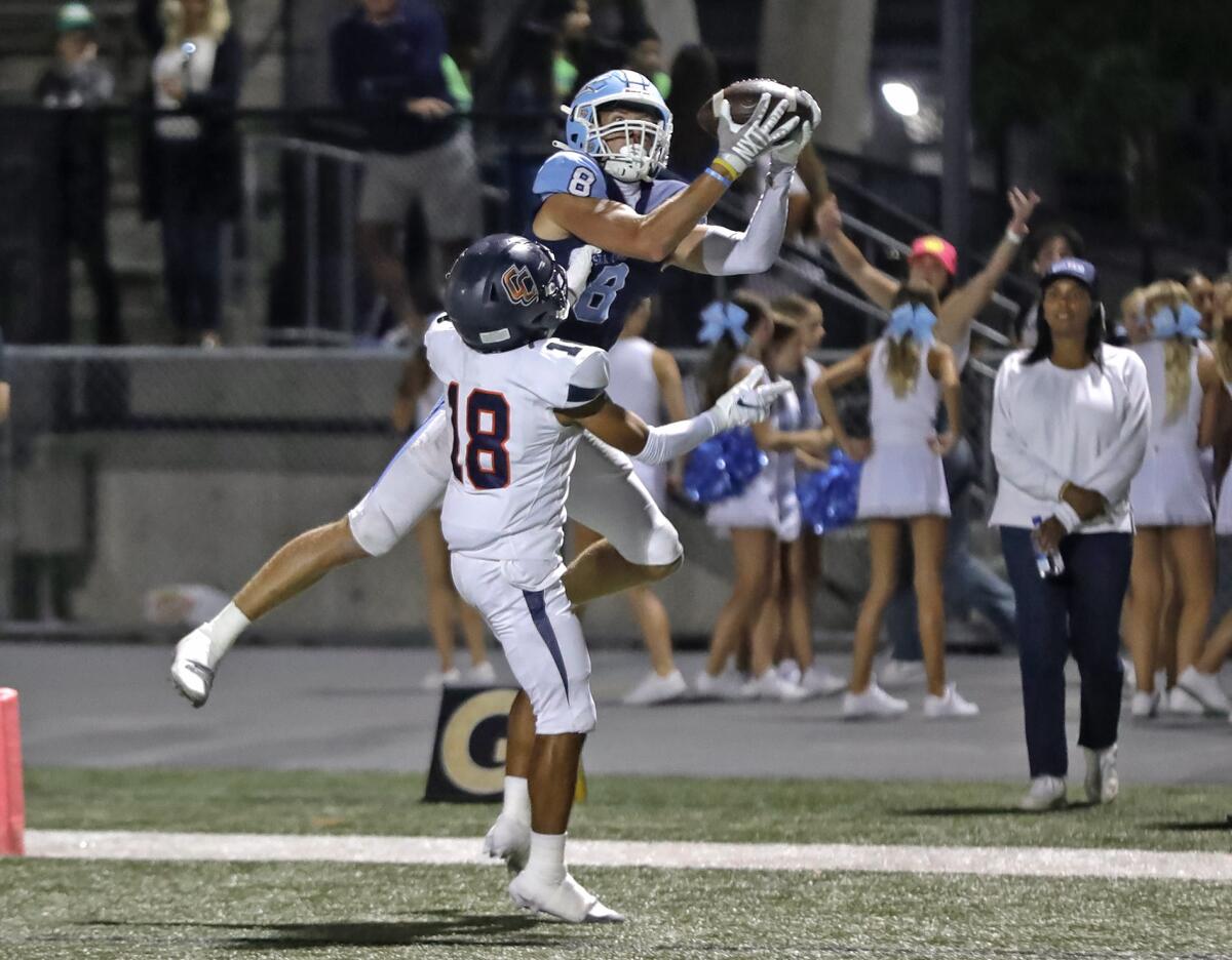 Corona del Mar receiver Russell Weir (8) makes a leaping touchdown catch during Friday's nonleague game against Cypress.