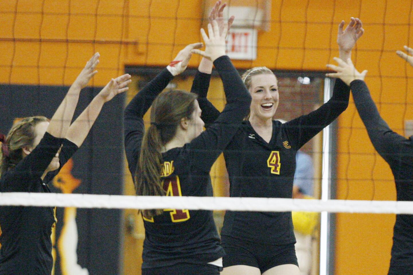 La Canada's Kendall Walbrecht gives her team a high five after making a point during a game against South Pasadena at South Pasadena High School on Thursday, September 27, 2012.