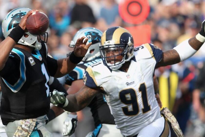 Rams defensive tackle Dominique Easley pressures Panthers quarterback Cam Newton during a Nov. 6 game.