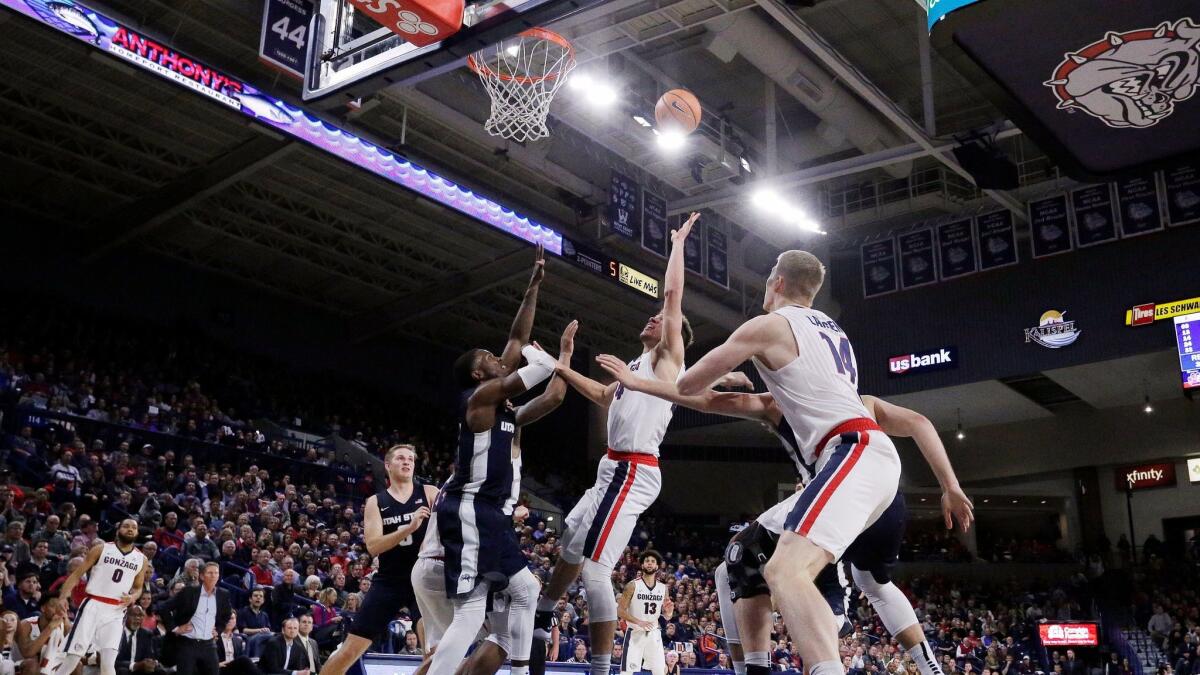 Gonzaga forward Corey Kispert shoots against Utah State guard DeAngelo Isby during the second half in Spokane, Wash.