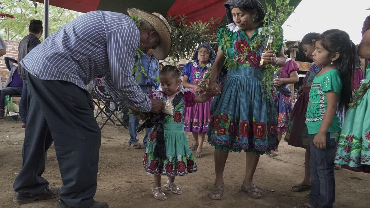 A christening party for Valentina Lopez, 3, in San Miguel del Valle, Oaxaca, which has long sent migrants to the U.S., including Valentina's father. He was in California until he returned several years ago.