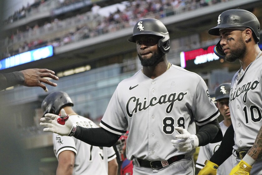 Chicago White Sox's Luis Robert (88) returns to the dugout after hitting a grand slam off Minnesota Twins pitcher Sonny Gray during the fourth inning of a baseball game, Thursday, July 14, 2022, in Minneapolis. (AP Photo/Jim Mone)