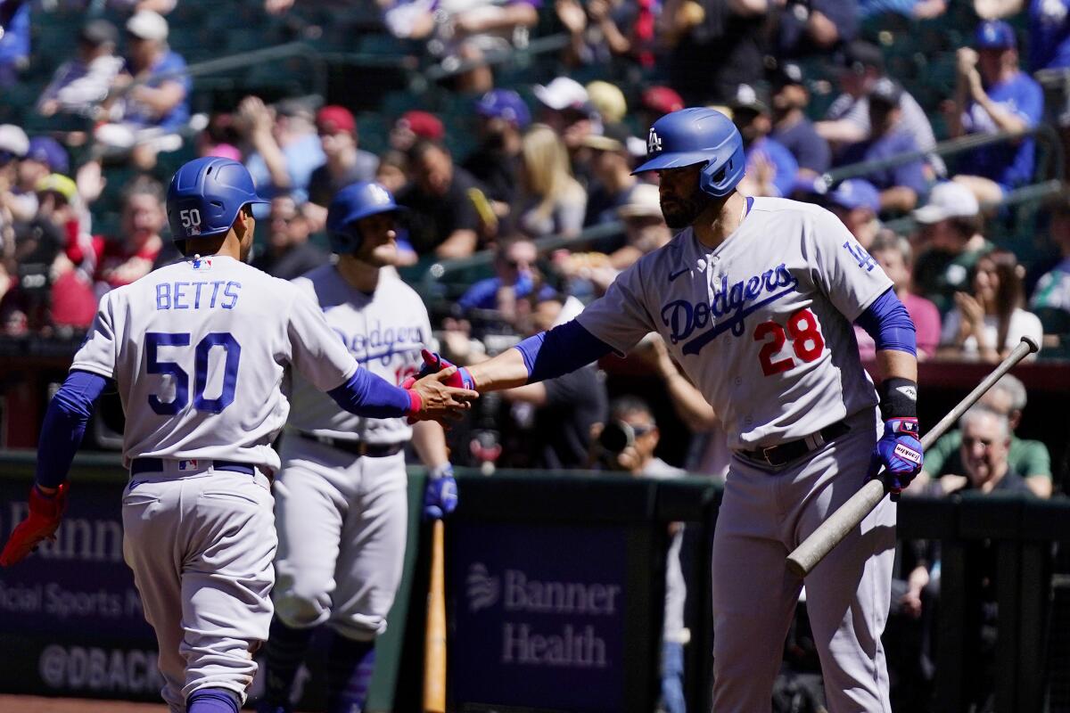 Mookie Betts celebrates with Dodgers teammate J.D. Martinez.