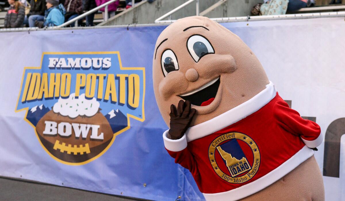 Spuddy Buddy, the Famous Idaho Potato Bowl mascot, cheers during second half action between the Utah State Aggies and the Akron Zips on Tuesday.