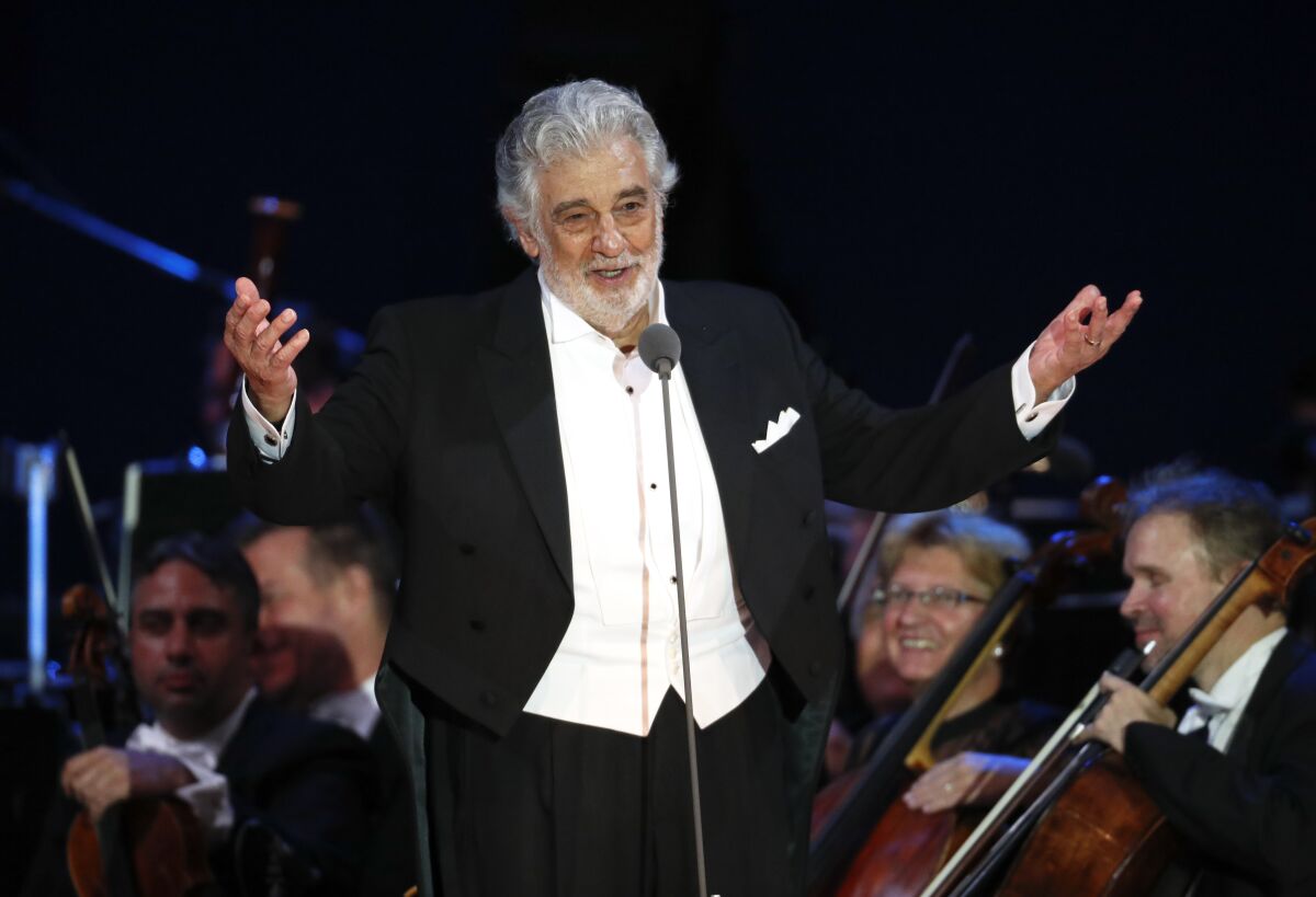 FILE - In this Aug. 28, 2019 file photo, opera star Placido Domingo salutes spectators at the end of a concert in Szeged, Hungary. The union that represents opera performers has launched its own investigation into sexual harassment allegations against Domingo, saying it cannot be sure that opera companies will delve into them sufficiently themselves. The American Guild of Musical Artists said its investigation was prompted by two Associated Press stories in which multiple women accused the opera legend of sexual harassment or other inappropriate conduct. (AP Photo/Laszlo Balogh, File)
