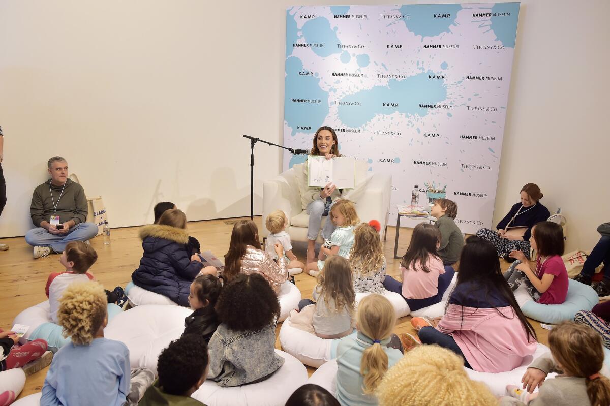 Elizabeth Chambers reads to children at the museum event.