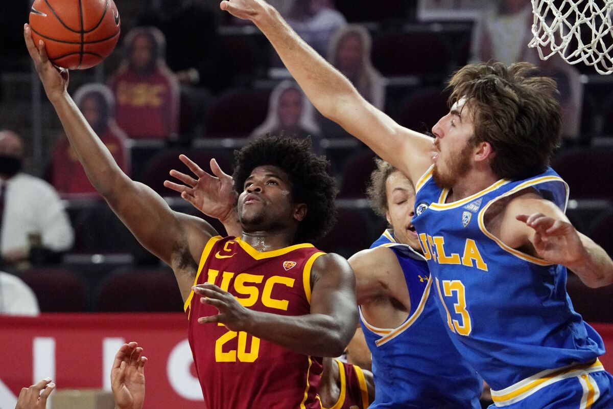 USC's Ethan Anderson tries to shoot amid defensive pressure from UCLA's Jake Kyman on Saturday.