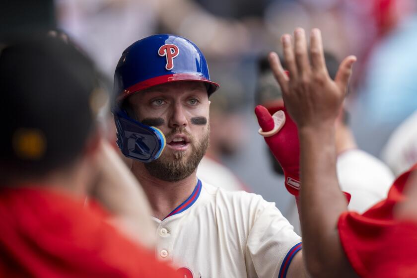 Philadelphia Phillies' Kody Clemens celebrates with teammates after scoring on a single by Nick Castellanos during the fifth inning of a baseball game against the Washington Nationals, Sunday, May 19, 2024, in Philadelphia. (AP Photo/Chris Szagola)