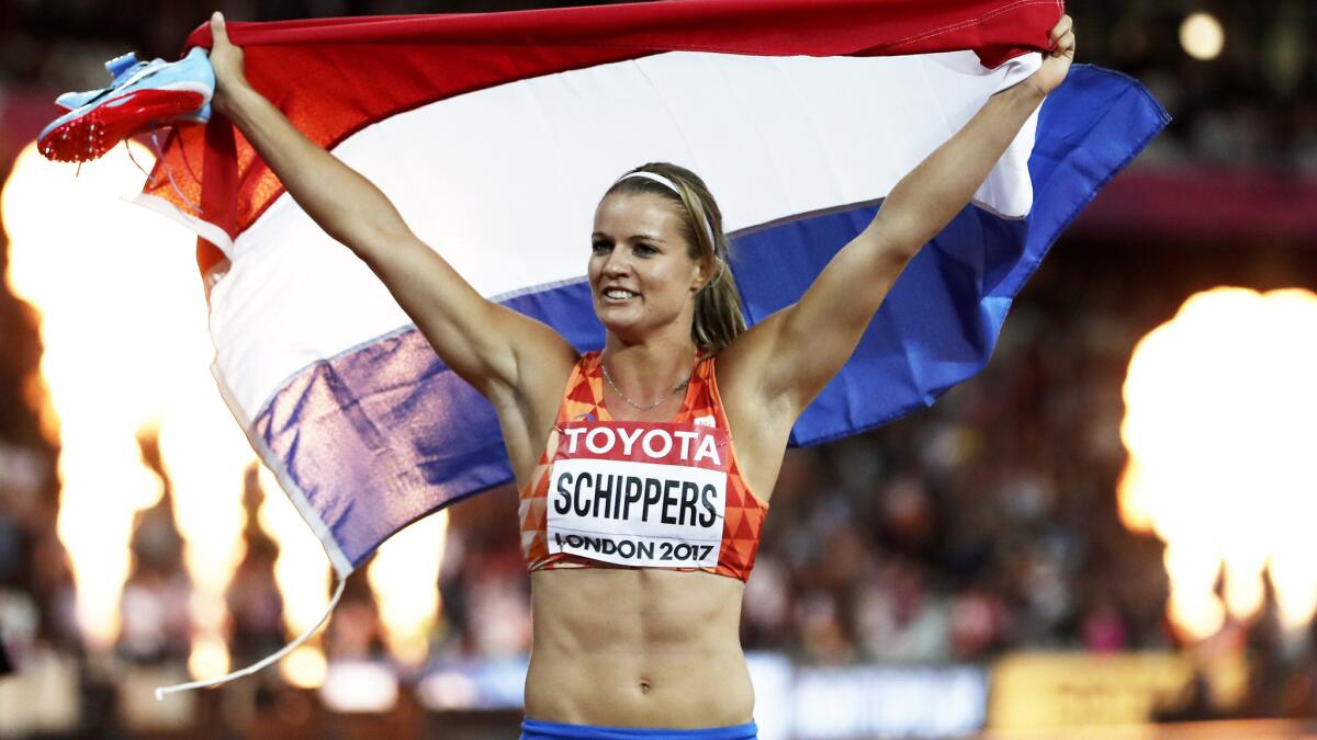 Dafne Schippers celebrates with the Dutch flag after winning the women's 200-meter race at the world championships on Friday.