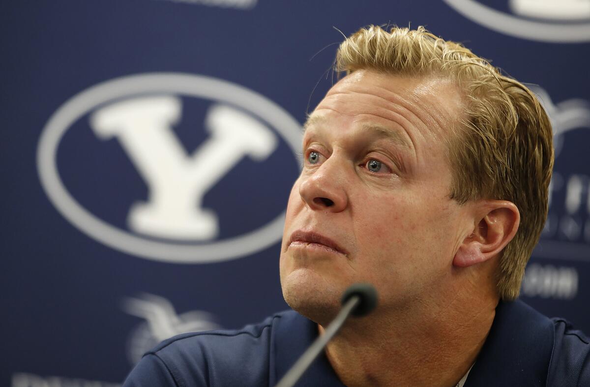 With tears in his eyes, BYU head football coach Bronco Mendenhall talks to the press on Friday annoucing his new coaching job at Virginia.