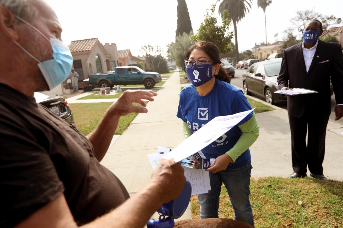L.A. City Council candidate Grace Yoo talks with resident Michael Turner on election day.