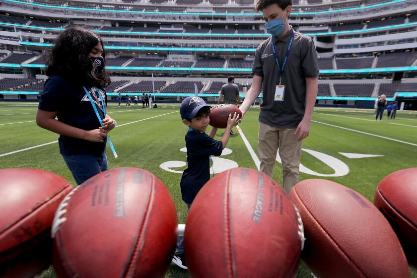 INGLEWOOD, CA - MAY 27, 2021: SoFi Stadium in Inglewood, home of the Los Angeles Rams and Chargers NFL teams, will feature digital technology to enhance the fan experience. Fans can try their hand at skills, strength and agility tests while having their results instantly tallied and sent to their smartphones. In addition, microchips embedded in player equipment and game balls can relay game, player, team and analytical information to fans as the action unfolds. (Luis Sinco / Los Angeles Times)