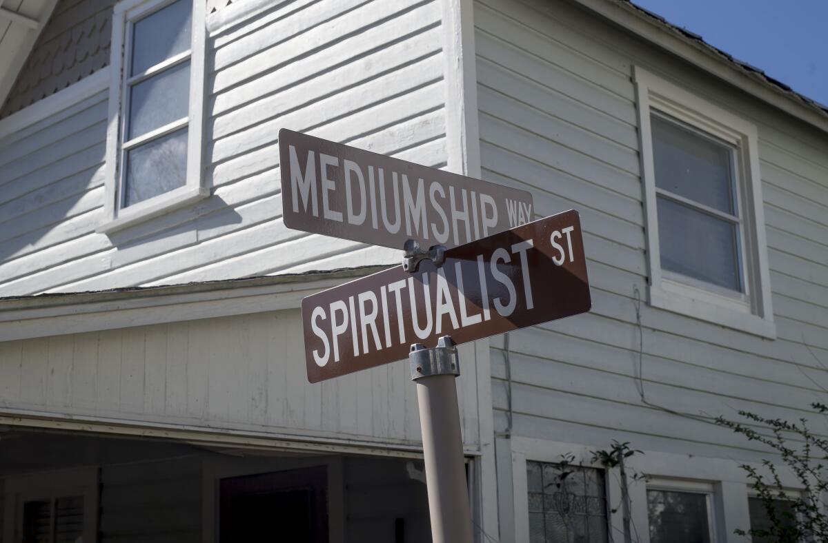 Road signs at the Cassadaga Spiritualist Camp in Cassadaga, Fla., read Mediumship Way and Spiritualist Street.