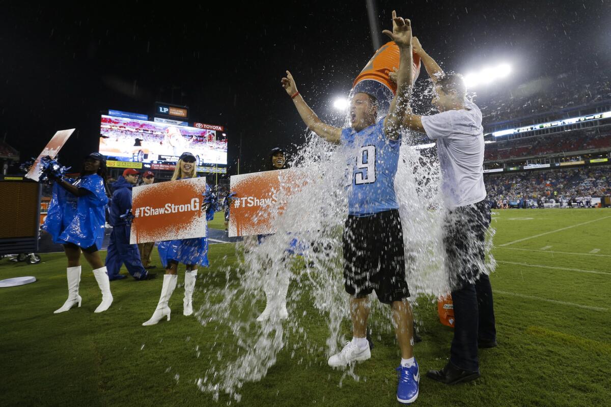 Former Tennessee Titans linebacker Tim Shaw is dunked as he takes the ALS Ice Bucket Challenge in the second quarter of a preseason football game between the Titans and the Minnesota Vikings Aug. 28. Shaw has announced that he has ALS.