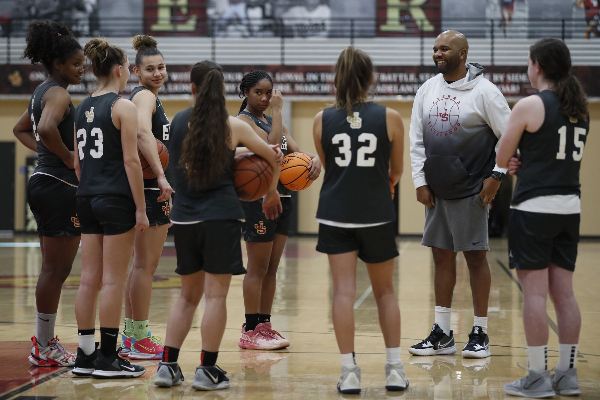 A coach talks to youth basketball team