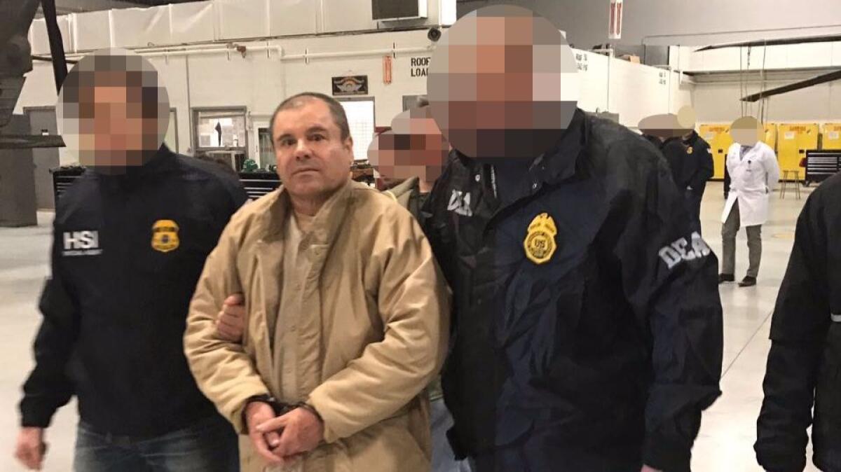 This handout picture released by the Mexican Interior Ministry on Jan. 20, 2017, shows Joaquin Guzman, a.k.a. "El Chapo," flanked by U.S. Drug Enforcement escorts as he is extradited to the United States on Jan. 19, 2017.